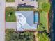 Aerial view of a light blue single-Gathering home with a private pool and well-maintained yard at 228 White Marsh Ln, Rotonda West, FL 33947