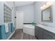 Bathroom with gray vanity cabinets, marble countertops, and a soaking tub at 228 White Marsh Ln, Rotonda West, FL 33947