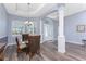 Elegant dining room with stylish lighting, wood floors, and ample natural light at 228 White Marsh Ln, Rotonda West, FL 33947