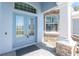Close up of the covered front entrance featuring double doors and stone accents at 228 White Marsh Ln, Rotonda West, FL 33947