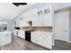 Modern kitchen with white cabinetry, gray backsplash, and stainless steel appliances at 228 White Marsh Ln, Rotonda West, FL 33947