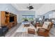Bright living room with ceiling fan, recessed lights and sliding glass doors that let in plenty of natural light at 228 White Marsh Ln, Rotonda West, FL 33947