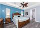 Spacious main bedroom featuring decorative ceiling fan and nautical accents at 228 White Marsh Ln, Rotonda West, FL 33947