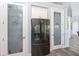 Pantry with decorative glass doors and stainless steel refrigerator at 228 White Marsh Ln, Rotonda West, FL 33947
