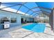 Refreshing screened-in pool features ample patio space for entertainment and relaxation at 228 White Marsh Ln, Rotonda West, FL 33947