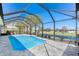 Beautiful screened-in pool with waterfront views and a serene atmosphere at 228 White Marsh Ln, Rotonda West, FL 33947