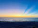 Beautiful sunrise over the ocean and sandy beach, creating a serene coastal atmosphere at 2405 N Beach Rd # 10, Englewood, FL 34223