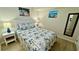Cozy bedroom with a tropical-themed bedspread and bright side tables at 2405 N Beach Rd # 10, Englewood, FL 34223