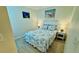 Cozy bedroom with wood-look flooring, soft lighting, and beach-themed decor for a relaxing atmosphere at 2405 N Beach Rd # 10, Englewood, FL 34223