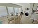Bright dining area with water views through large windows perfect for waterfront lifestyle at 2405 N Beach Rd # 10, Englewood, FL 34223