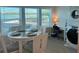 Bright dining area with water views through large windows perfect for waterfront lifestyle at 2405 N Beach Rd # 10, Englewood, FL 34223