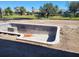 An empty in-ground pool in backyard under construction with a blue sky overhead at 254 White Marsh Ln, Rotonda West, FL 33947