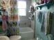 Bathroom with a shower/tub with a curtain, a toilet and shelving at 26191 Angelica Rd, Punta Gorda, FL 33955