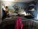 Bedroom with comfortable bed, featuring ample storage and eclectic decor at 26191 Angelica Rd, Punta Gorda, FL 33955