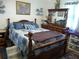 Comfortable bedroom with wooden furniture, soft blue pillows, and ample natural light at 26191 Angelica Rd, Punta Gorda, FL 33955