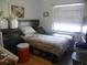 This bedroom features a window, wood floor, and neutral colored walls at 26191 Angelica Rd, Punta Gorda, FL 33955