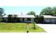 A charming single-story home boasting a well-manicured lawn and a detached two-car garage at 26191 Angelica Rd, Punta Gorda, FL 33955