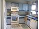 Traditional kitchen with white appliances and cabinets at 26191 Angelica Rd, Punta Gorda, FL 33955