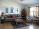 Spacious living room with hardwood floors, a large sofa, and decorative mirrors on the wall at 26191 Angelica Rd, Punta Gorda, FL 33955