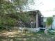 Enclosed patio in the backyard surrounded by trees and grass at 26191 Angelica Rd, Punta Gorda, FL 33955
