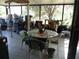 Enclosed patio with tile floor and filled with boxes, containers and furniture at 26191 Angelica Rd, Punta Gorda, FL 33955