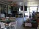 Enclosed patio with tile floor and filled with boxes, containers and furniture at 26191 Angelica Rd, Punta Gorda, FL 33955