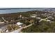 Aerial view of waterfront property with canal access and paved driveway at 3021 Holly Ave, Englewood, FL 34224