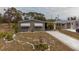 An aerial view highlights the house exterior with a driveway and beautiful yard at 3021 Holly Ave, Englewood, FL 34224