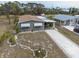 Aerial view of house showcasing the roof, driveway, landscaping, and surrounding properties at 3021 Holly Ave, Englewood, FL 34224