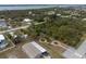 Aerial view of a home near the ocean with a landscaped front and paved parking at 3021 Holly Ave, Englewood, FL 34224