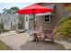 Cozy backyard with a colorful patio set, ideal for outdoor relaxation at 3021 Holly Ave, Englewood, FL 34224