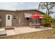 Charming backyard with patio, table, and colorful chairs at 3021 Holly Ave, Englewood, FL 34224
