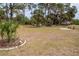 Large, grassy backyard offering plenty of room for activities and outdoor entertaining at 3021 Holly Ave, Englewood, FL 34224