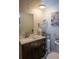 Bathroom with a vanity with a storage cabinet, updated fixtures, mirror, and white shiplap wall at 3021 Holly Ave, Englewood, FL 34224