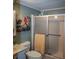 Bathroom featuring a shower with sliding glass doors, toilet, and framed artwork on the wall at 3021 Holly Ave, Englewood, FL 34224