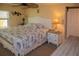 Cozy bedroom showcasing a comfortable bed, ceiling fan, and a bright window for natural light at 3021 Holly Ave, Englewood, FL 34224