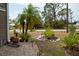 Landscaped front yard featuring rock beds, various plants, and decorative planters enhancing the curb appeal at 3021 Holly Ave, Englewood, FL 34224