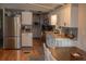 Spacious kitchen featuring stainless steel appliances, white cabinets, and an adjacent dining area at 3021 Holly Ave, Englewood, FL 34224