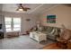 The living room has lots of natural light and a ceiling fan at 3021 Holly Ave, Englewood, FL 34224