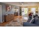 Living room with view into dining area and access to lanai at 3021 Holly Ave, Englewood, FL 34224