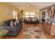 The living room features a ceiling fan, lots of natural light and comfortable seating at 3021 Holly Ave, Englewood, FL 34224