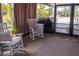Covered and screened patio with rocking chairs and an open view at 3021 Holly Ave, Englewood, FL 34224