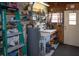 Utility room with shelving, water heater, laundry sink, and workspace at 3021 Holly Ave, Englewood, FL 34224