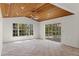 Spacious living area with unique wood ceiling, recessed lighting, and a view of the pool through sliding glass doors at 3391 Crystal Lakes Ct, Sarasota, FL 34235