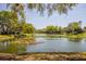 Scenic view of the pond showcasing the peaceful and natural setting of the property's community at 3391 Crystal Lakes Ct, Sarasota, FL 34235