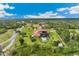 Expansive estate aerial view featuring a pool, fountain, circular drive, lush lawns and mature trees at 3700 Como St, Port Charlotte, FL 33948