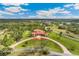 Stunning estate featuring mature landscaping, a circular driveway, and expansive lawns at 3700 Como St, Port Charlotte, FL 33948