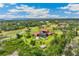 Estate home with pool, surrounded by manicured grounds and mature trees in a private setting at 3700 Como St, Port Charlotte, FL 33948