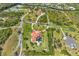 Expansive aerial view showcases the property's generous lot, lush landscaping, and private pool area at 3700 Como St, Port Charlotte, FL 33948