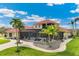 View of the backyard, screened in pool, patio, and tropical landscaping at 3700 Como St, Port Charlotte, FL 33948